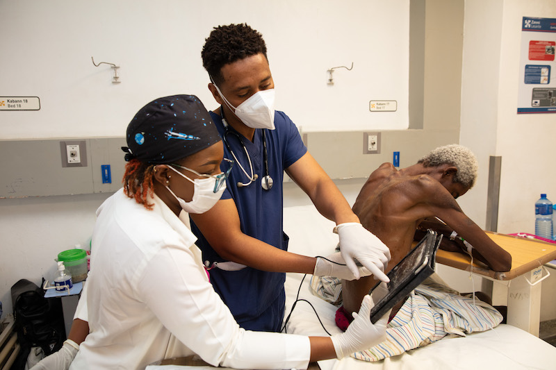 Dr. Obed-Edson Lamy. Orelus Odnel, 44 years old, having fluid removed from his lungs by Dr. Lamy...Hopital Universitaire de Mirebalais (HUM) in Mirebalais, Haiti, on March 24, 2023. 