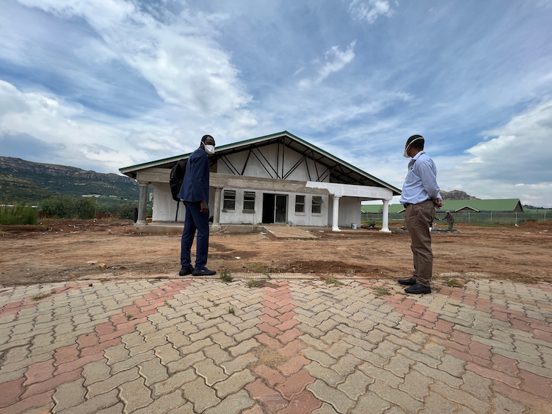 PIH-Lesotho Executive Director Melino Ndayizigiye (left) and his colleague Dr. Meseret Tamirat (right) at the site of the nearly completed COVID-19 isolation center at Botsabelo Hospital. 