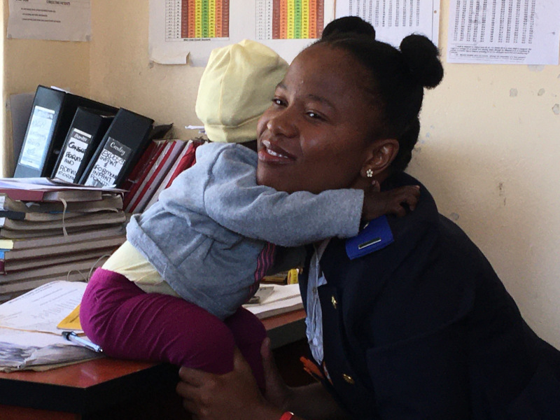 PIH nurse midwife Litlhare Nkhati holds 9-month-old Karabo Makhele at Methalaneng in October 2019.