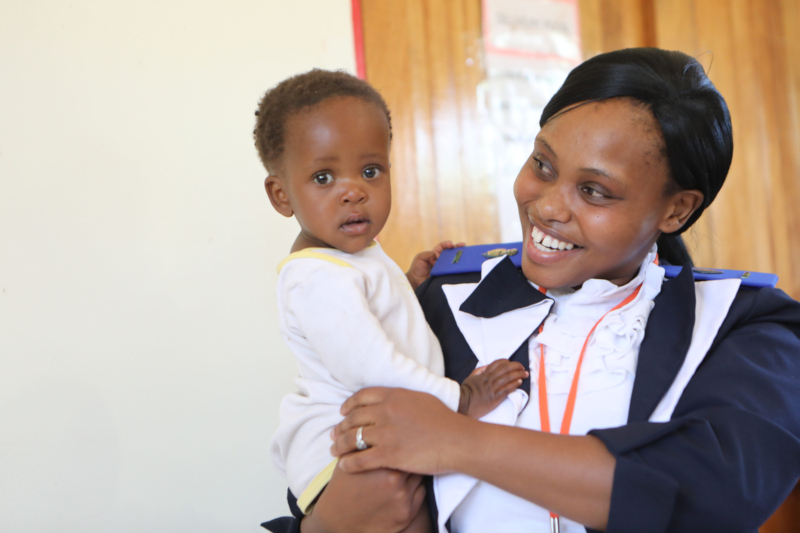 Nurse Malineo Ts’oeunyane with Puleng Khahlana, 9 months old, at a mother/child health clinic in Nkau, Lesotho