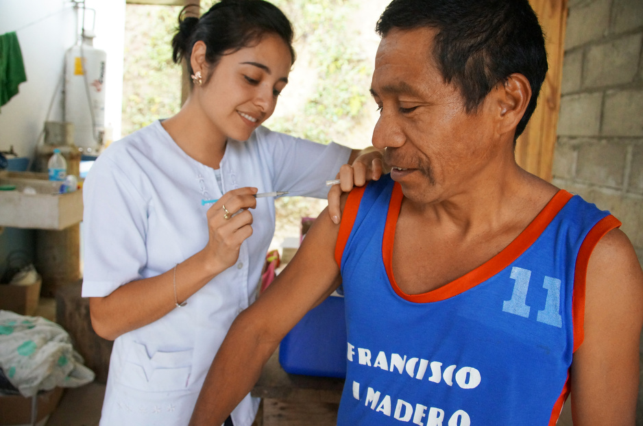 In this picture, Krysthal Dardon, a nurse, steadies a man’s arm before administering a vaccine at a rural clinic in Matasano in March 2014.