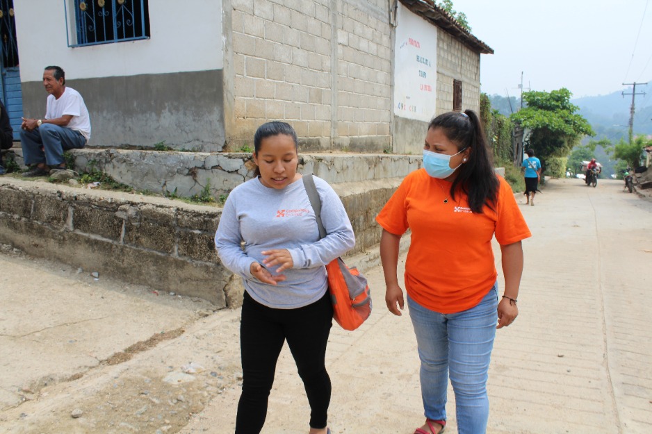 Mayra Ramirez walks with a colleague through Salvador Urbina, a rural community in Chiapas, Mexico, where Compañeros En Salud provides medical care and social support.