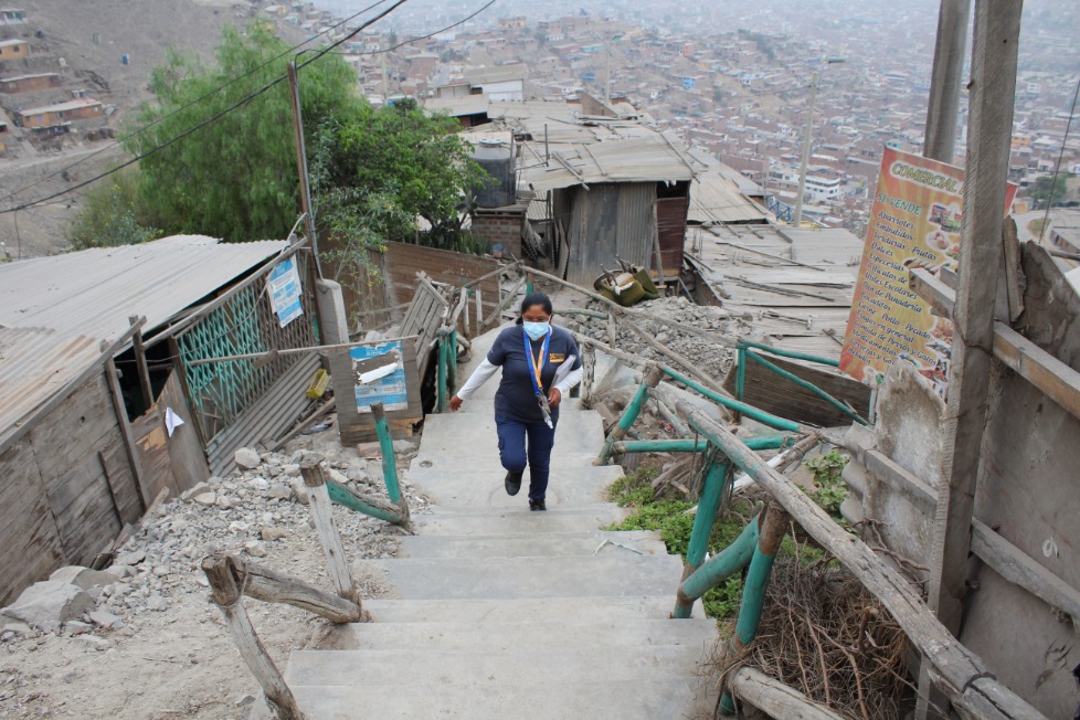 Cristina Capristano walks through the remote hillside communities of Carabayllo.