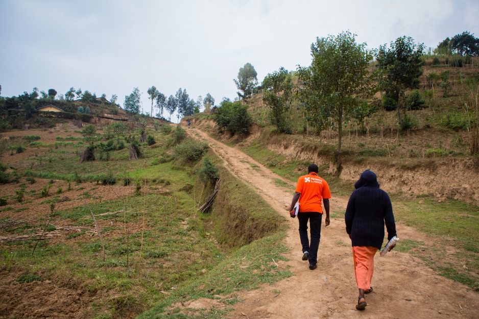 PIH staff walk up a dirt road in Butaro, Rwanda, where PIH works.