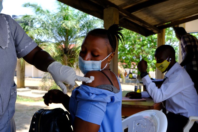 woman receives COVID-19 vaccination in Sierra Leone