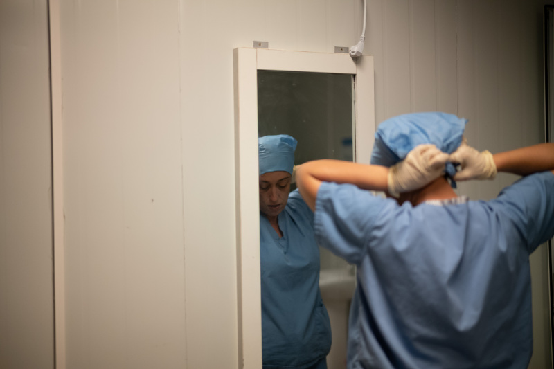 Dr. Marta Lado has a solitary moment while putting on scrubs for PIH Sierra Leone 