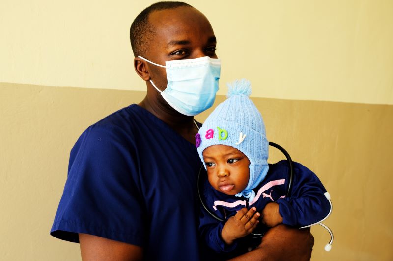 pediatrician holds his patient in Sierra Leone