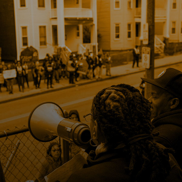 Tinted Image of a protestor using a bullhorn