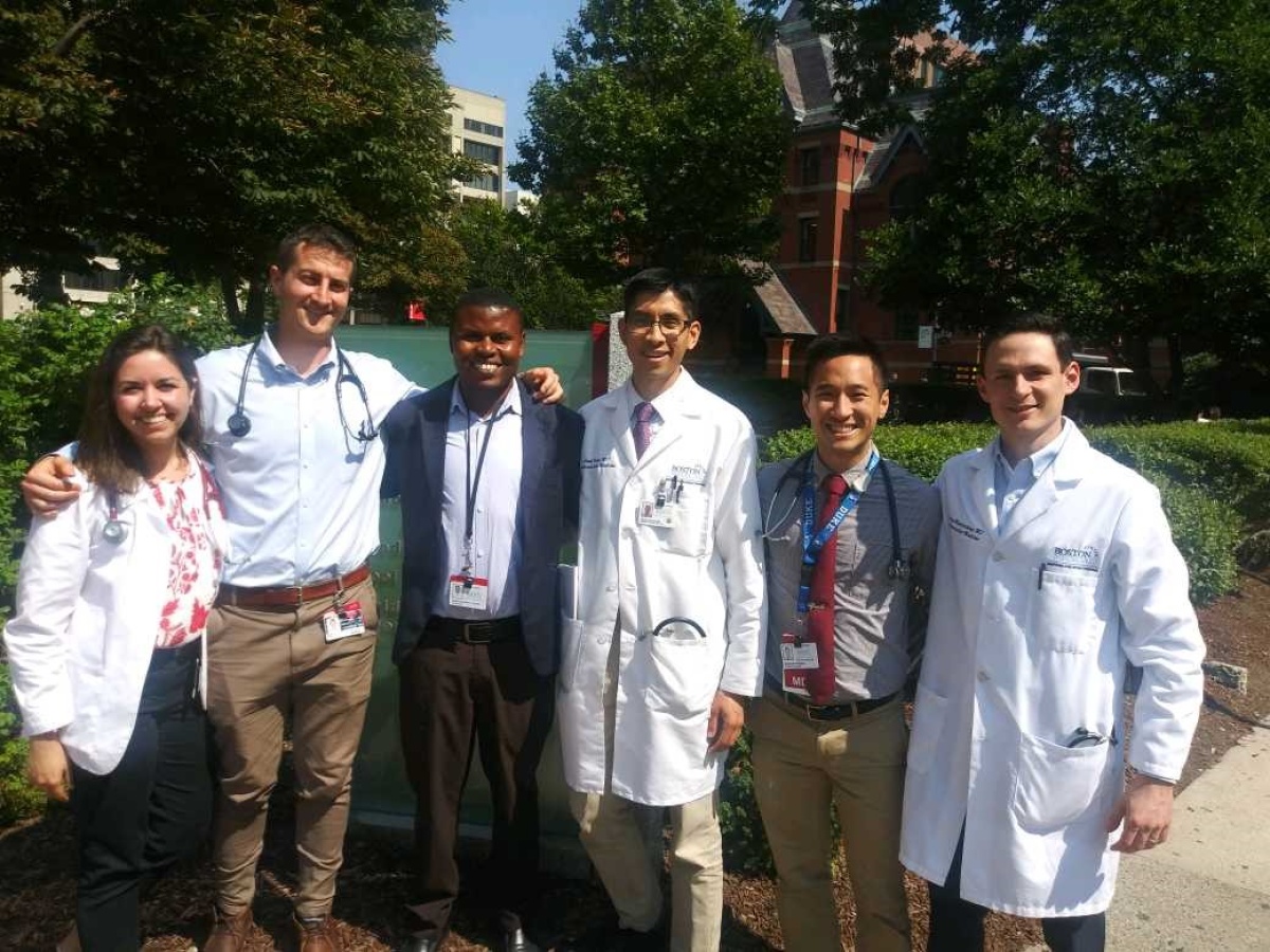 Heart surgery patient stands with medical colleagues outside BU's School of Medicine