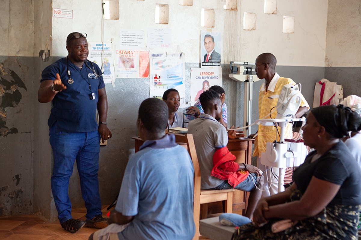 PIH clinician provides information to patients awaiting care