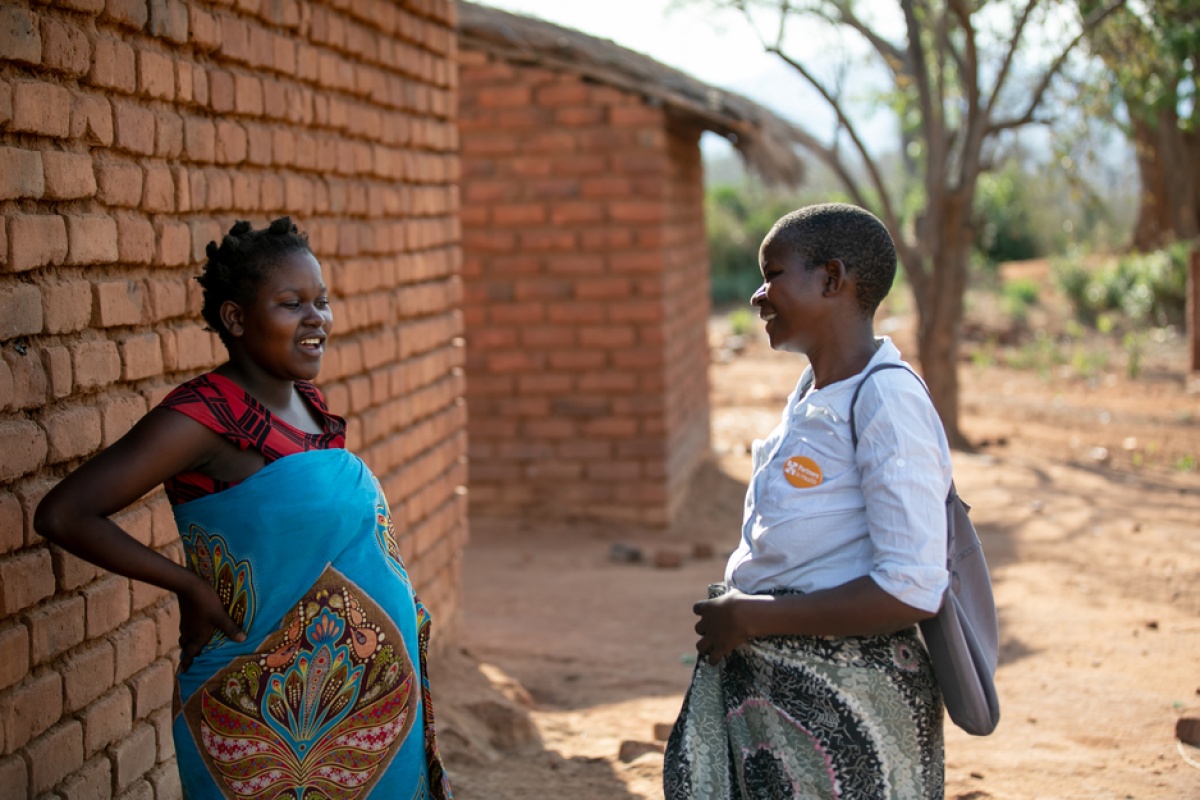 Eliza Kazembe and community health worker Grace Mgaiwa 