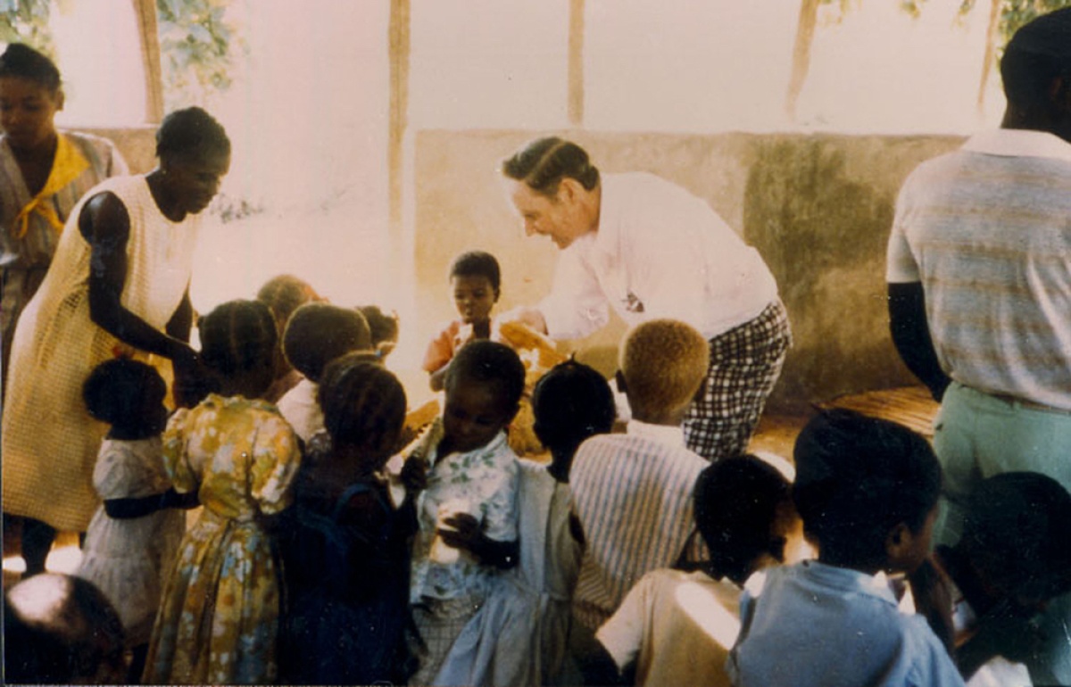 Tom White greeting children in a clinic in Cange, Haiti