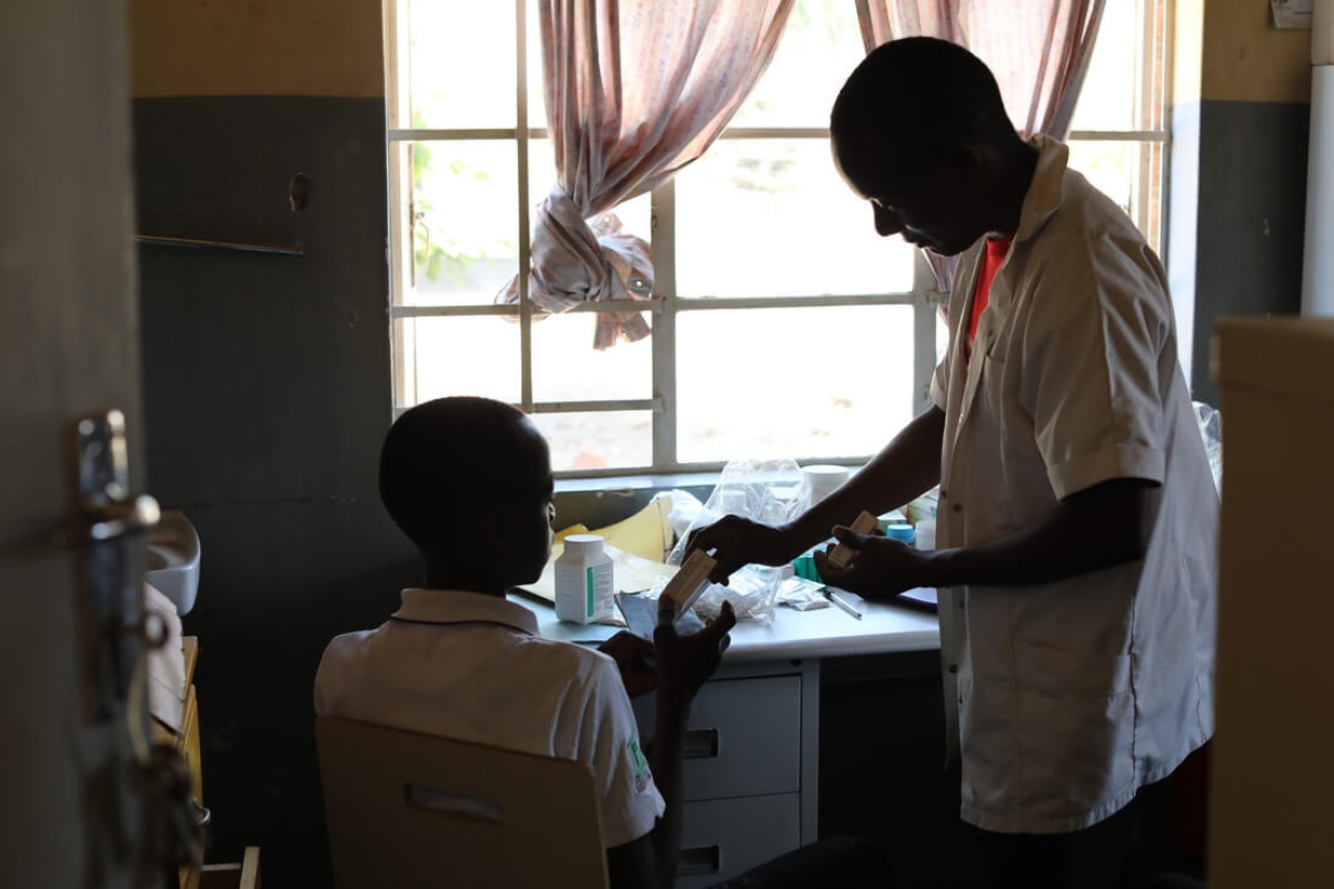 NCD nurse Victor Kaphaso with teen diabetes patient Kerefasi Wiliyamu at Lisungwi Community Hospital in Malawi 