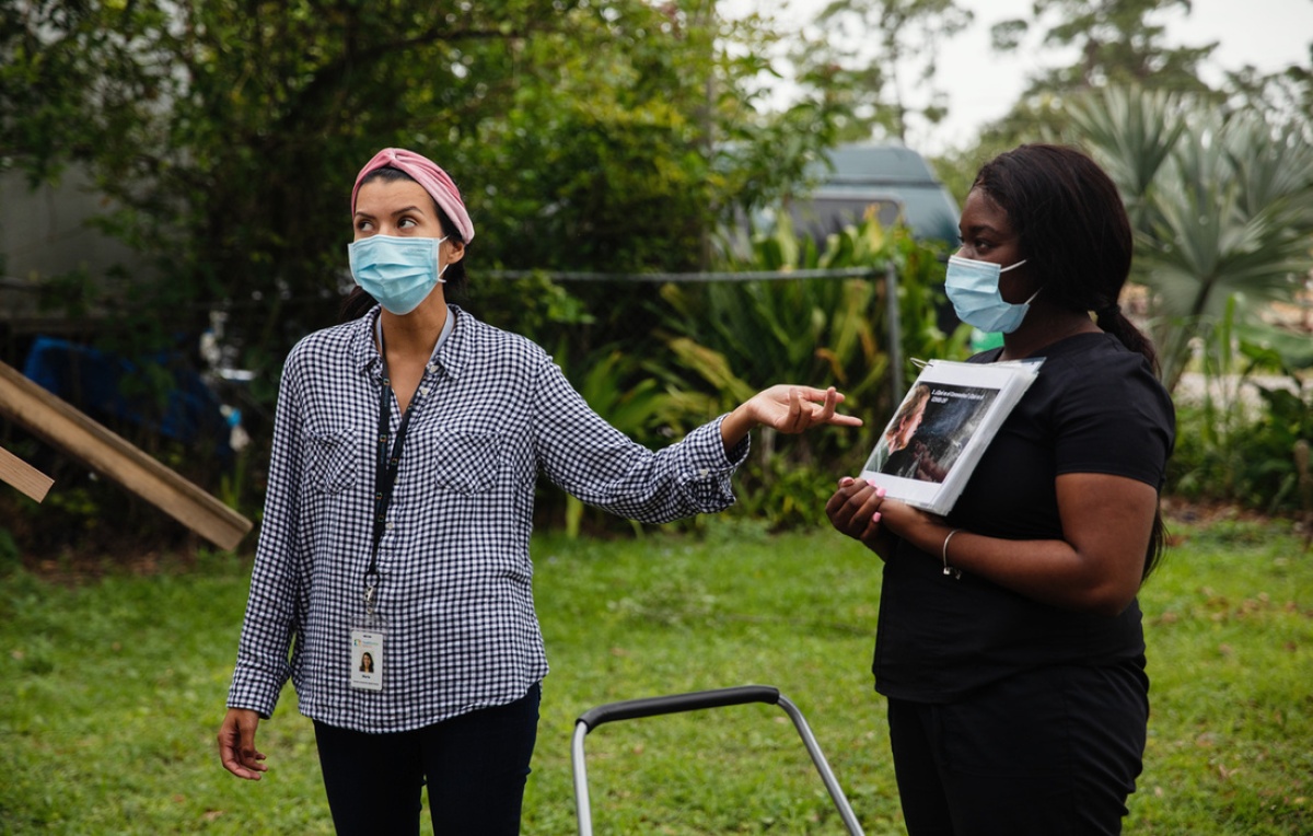 A health promoter giving an informational presentation about Covid-19 in Florida