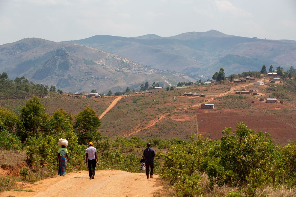 staff walk along road following a home visit in rural Malawi