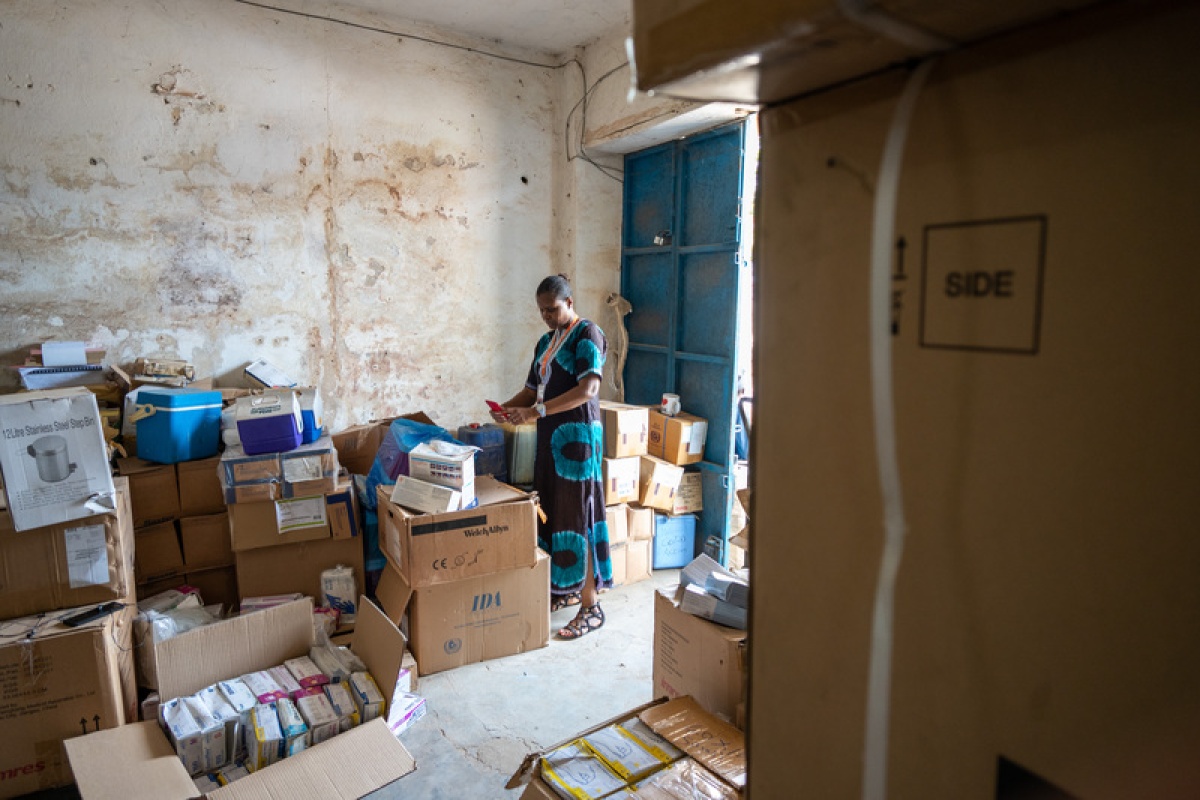 Vicky Reed, director of nursing for PIH Sierra Leone, checks PPE and other COVID-19 supplies 