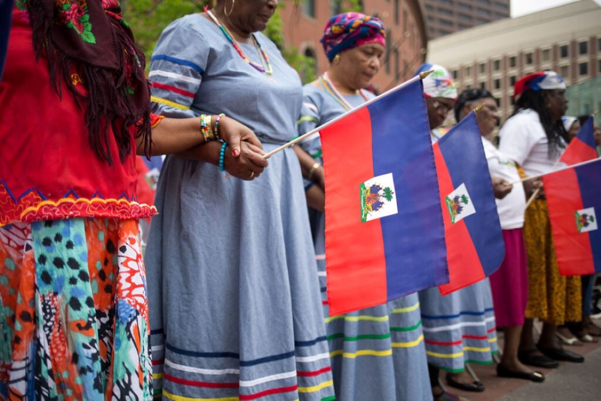 women hold Haitian flag in downtown Boston