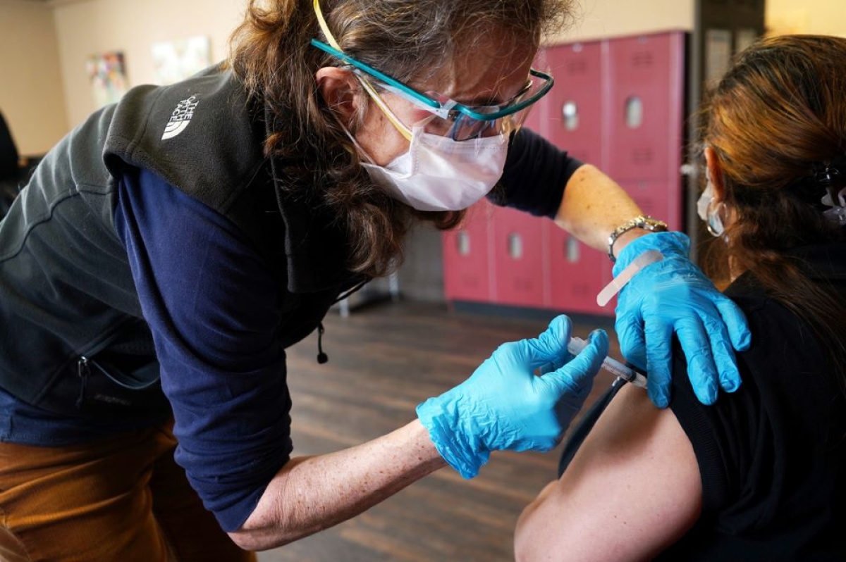 nurse administers COVID-19 vaccine to staff at homeless shelter in Boston 