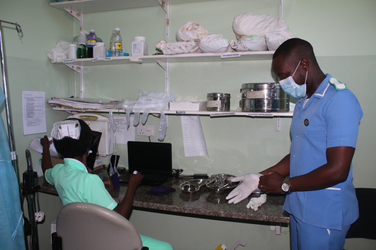Isaac Mphande prepares to assist a patient in the family planning room at Neno District Hospital.