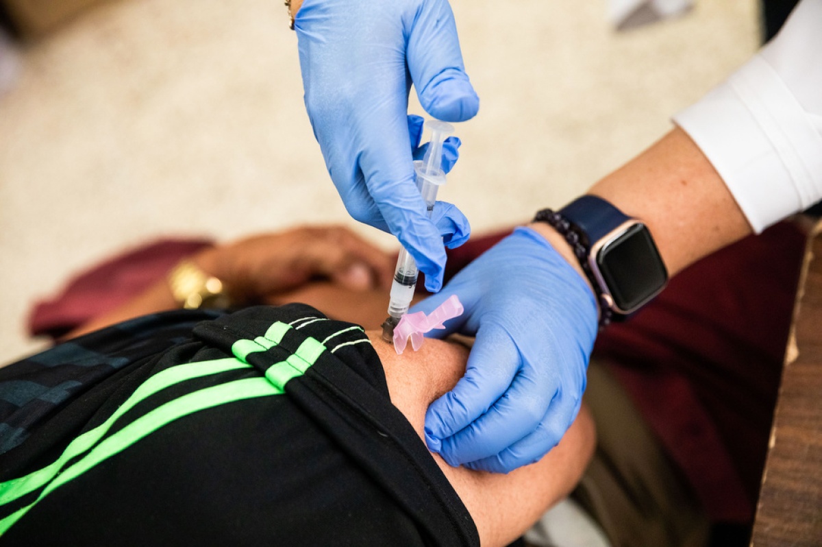 Health care worker Lazara Hurtado inoculates an Immokalee resident with a COVID-19 vaccine in Immokalee, Florida in May 2021.