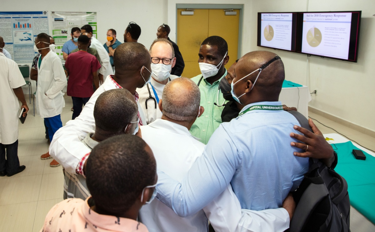 Dr. Paul Farmer speaks with clinicians at Hopital University de Mirebalais.