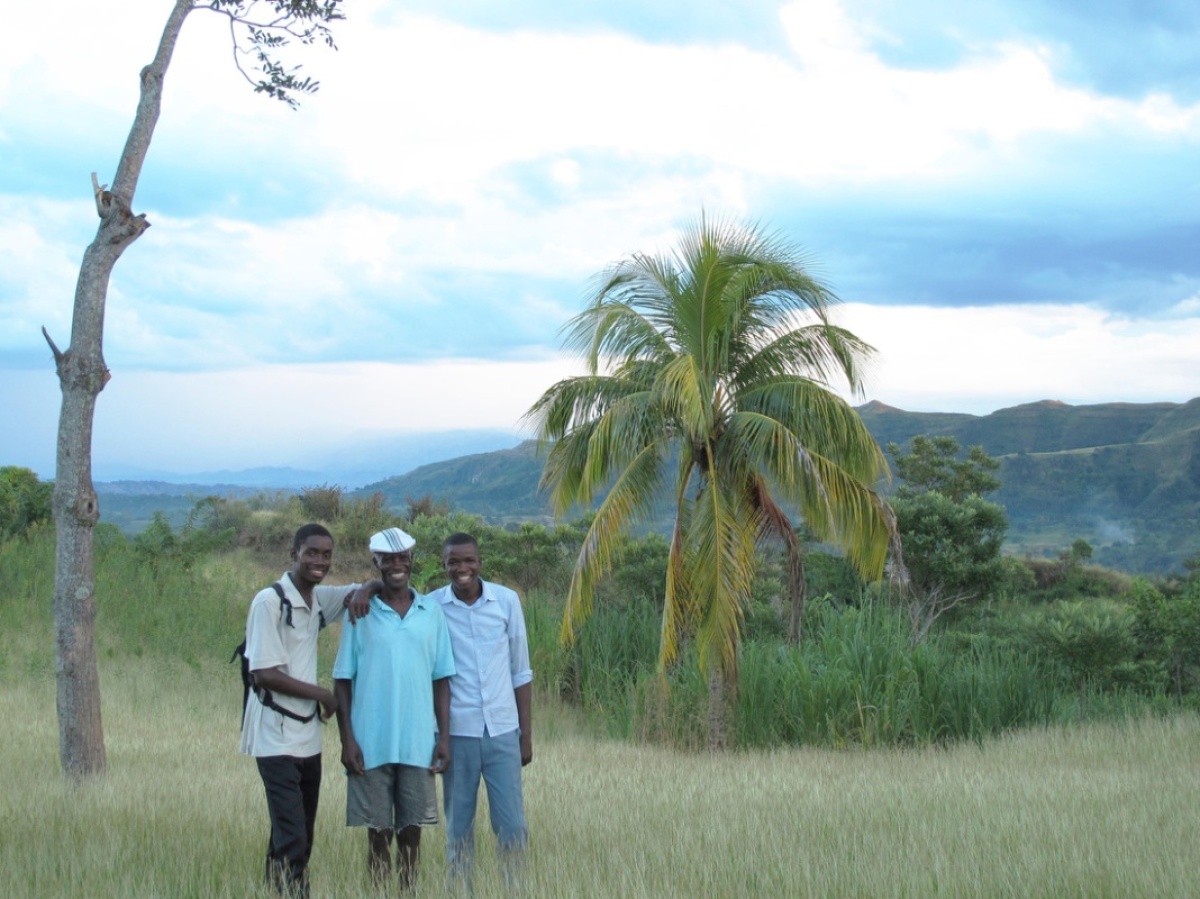 Haitian farmer St. Ker François stands with his family. He received HIV treatment for more than a decade from PIH community health workers.
