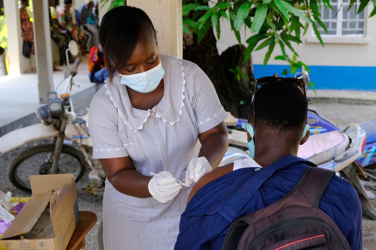 Sylvia Y. Kamara, a nurse with Sierra Leone's Ministry of Health, administers a COVID-19 vaccine in March 2021.