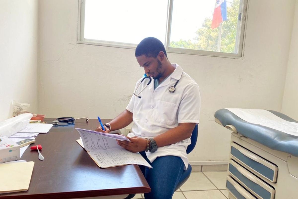 Family medicine doctor reviews patient file in Haiti