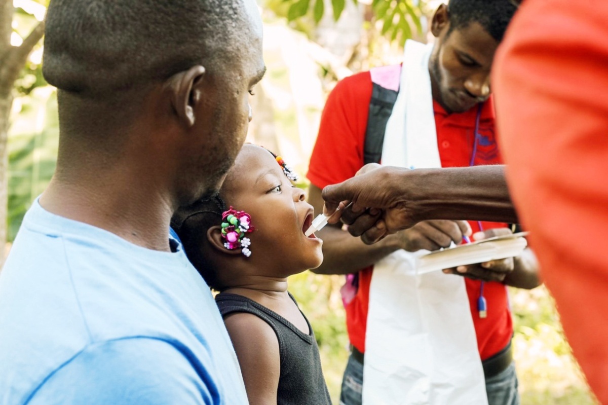Johnson Guerrier and his two-year-old daughter received the oral cholera vaccine as part of a recent campaign in Mirabelais, Haiti. 