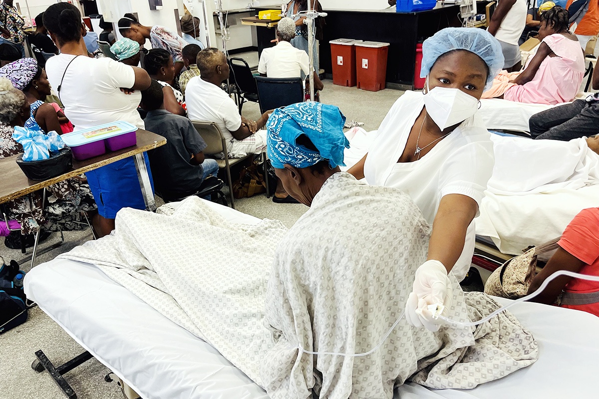 Nurse Achlande Accilien cares for a patient in the packed emergency room at Hôpital Universitaire de Mirebalais on March 23, 2023.