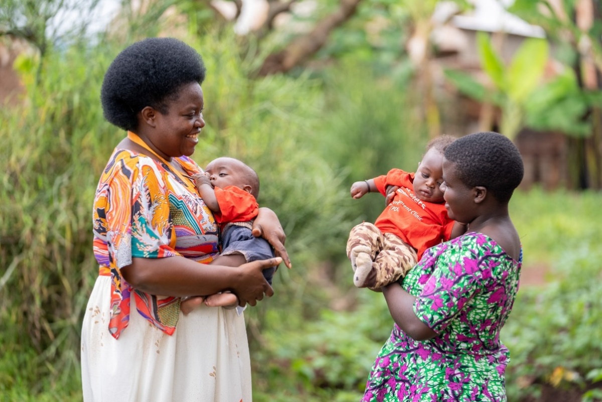 Cecile Itangishaka, IMB's psychosocial and community support coordinator, chats with Solange Manirumva about her babies health during a routine home visit.
