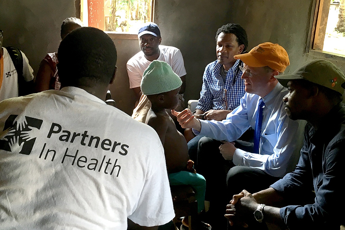 Dr. Paul Farmer examines an 8-year-old tuberculosis patient, during a home visit in Maryland County, Liberia.