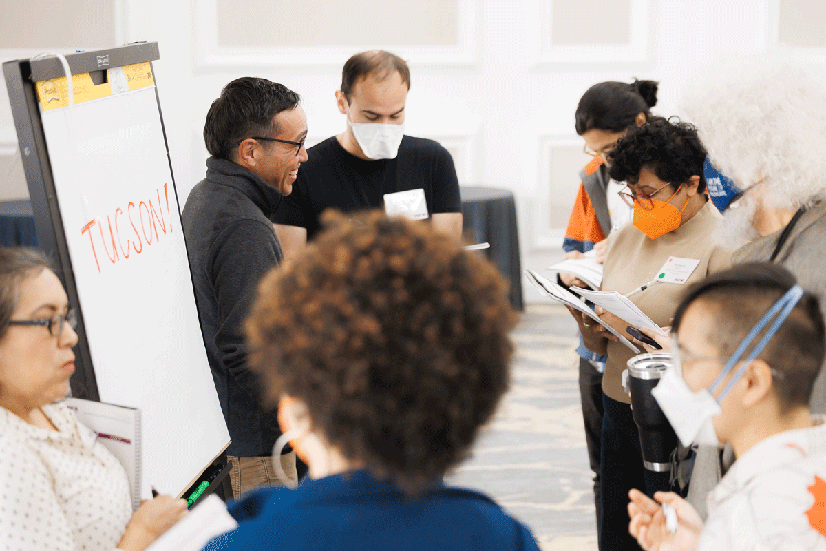 Dylan Baysa speaks to colleagues