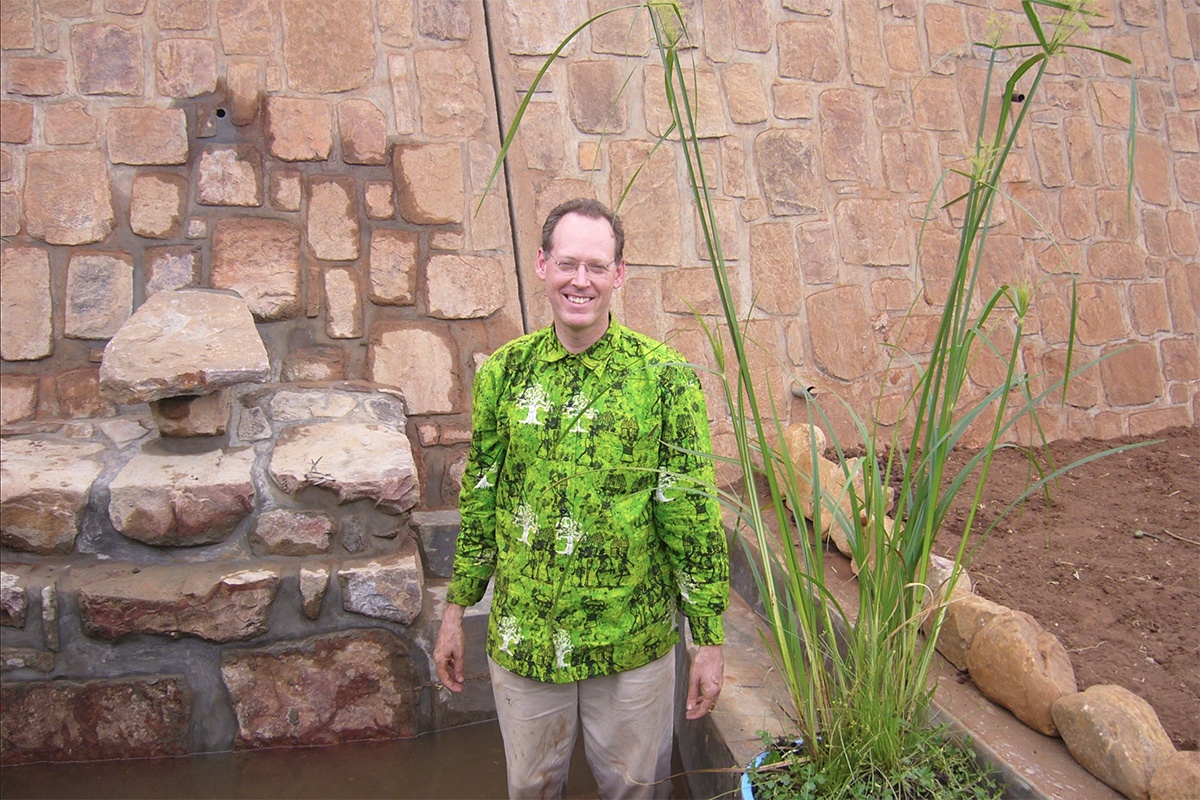 The late Dr. Paul Farmer stands in what will become a large garden in Rwinkwavu, Rwanda.