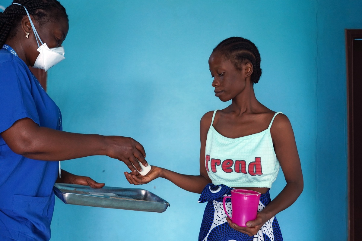 With support from arcTB, Ministry of Health registered nurse Beatrice M. Lehkaryean, left, provides the new WHO-approved regimen for multidrug-resistant tuberculosis to Comfort Yarkpawolo at the TB-Annex Hospital in Montserrado County, Liberia.