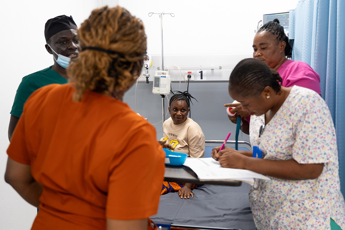 Staff and patient Fatmata Jalloh in the triage area at the MCOE
