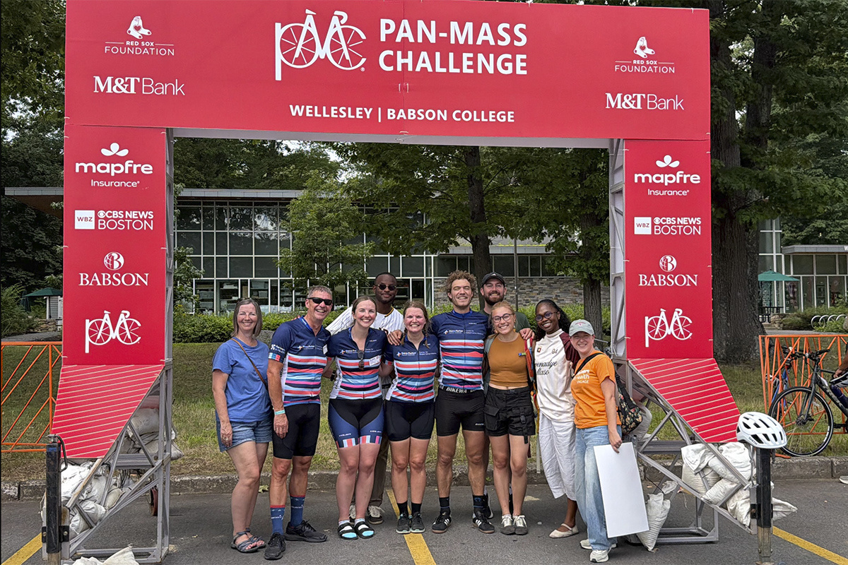 Members of Ekip Onkoloji, Partners In Health's PMC team, celebrate with friends and family at the finish line in Wellesley. 