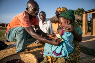CHW Samuel Saidi checking for malnutrition in Kaingirira Village, Malawi