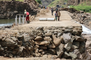 Community members walk on the crumbled Mants’onyane bridge in rural Lesotho 