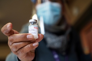  Toni K. Williams RN shows a vial of the Moderna COVID vaccine