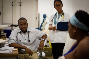 two clinicians meet with a patient with breast cancer