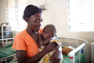 Chisomo Tigone, 7 months, is held by his mother, Flora Tigone, while undergoing treatment for severe malaria in Lisungwi, Malawi.