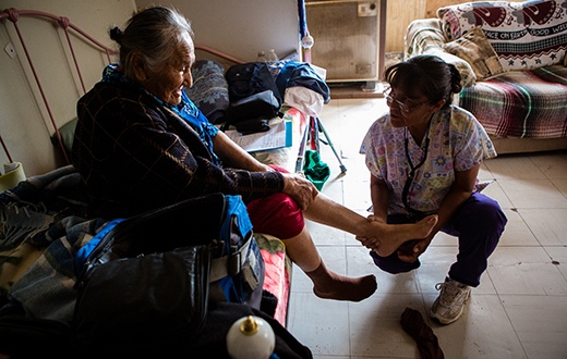 Nurse treating elderly woman in the Navajo Nation