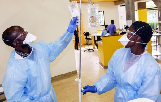nurses in Rwanda prepare IV fluid for cancer patients