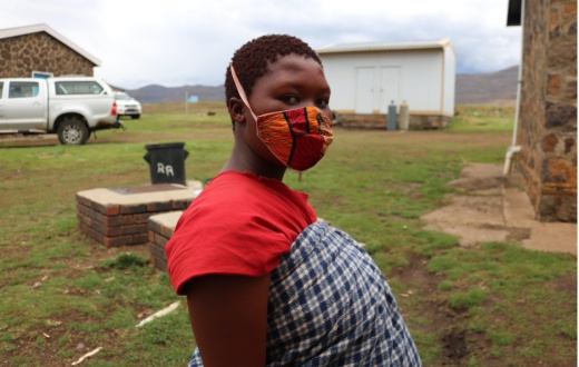Limakatso Lerata stands near the maternal waiting home where she is staying in the weeks leading up to her delivery.