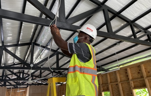 Jimmy Forest installs electrical infrastructure for the COVID-19 ward at PIH-supported University Hospital in Mirebalais, Haiti, in spring 2020.