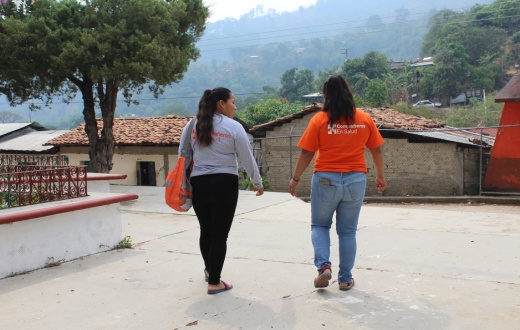 Mayra Ramirez (left), walks with a colleague from Compañeros En Salud, as Partners In Health is known in Mexico.