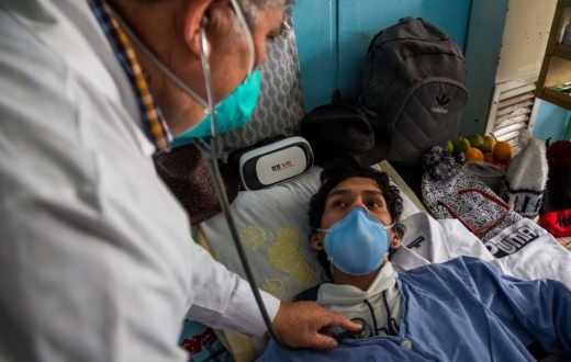 a clinician examines a tuberculosis patient in Peru