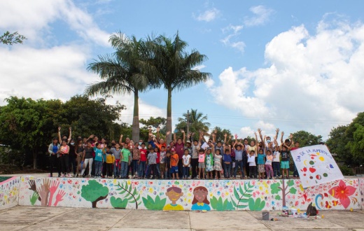 Teens and youth stand by a mural painted at the end of a three-day workshop on reproductive rights hosted by Compañeros En Salud, as Partners In Health is known in Mexico.