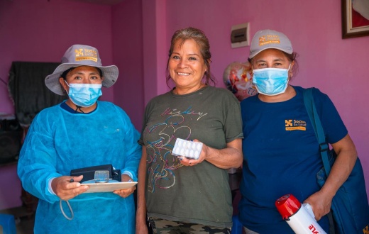 Meysi Mendoza (center) stands with Elizabeth Anchante (left) and Guadalupe (right), community health workers with Socios En Salud, as Partners In Health is known in Peru.